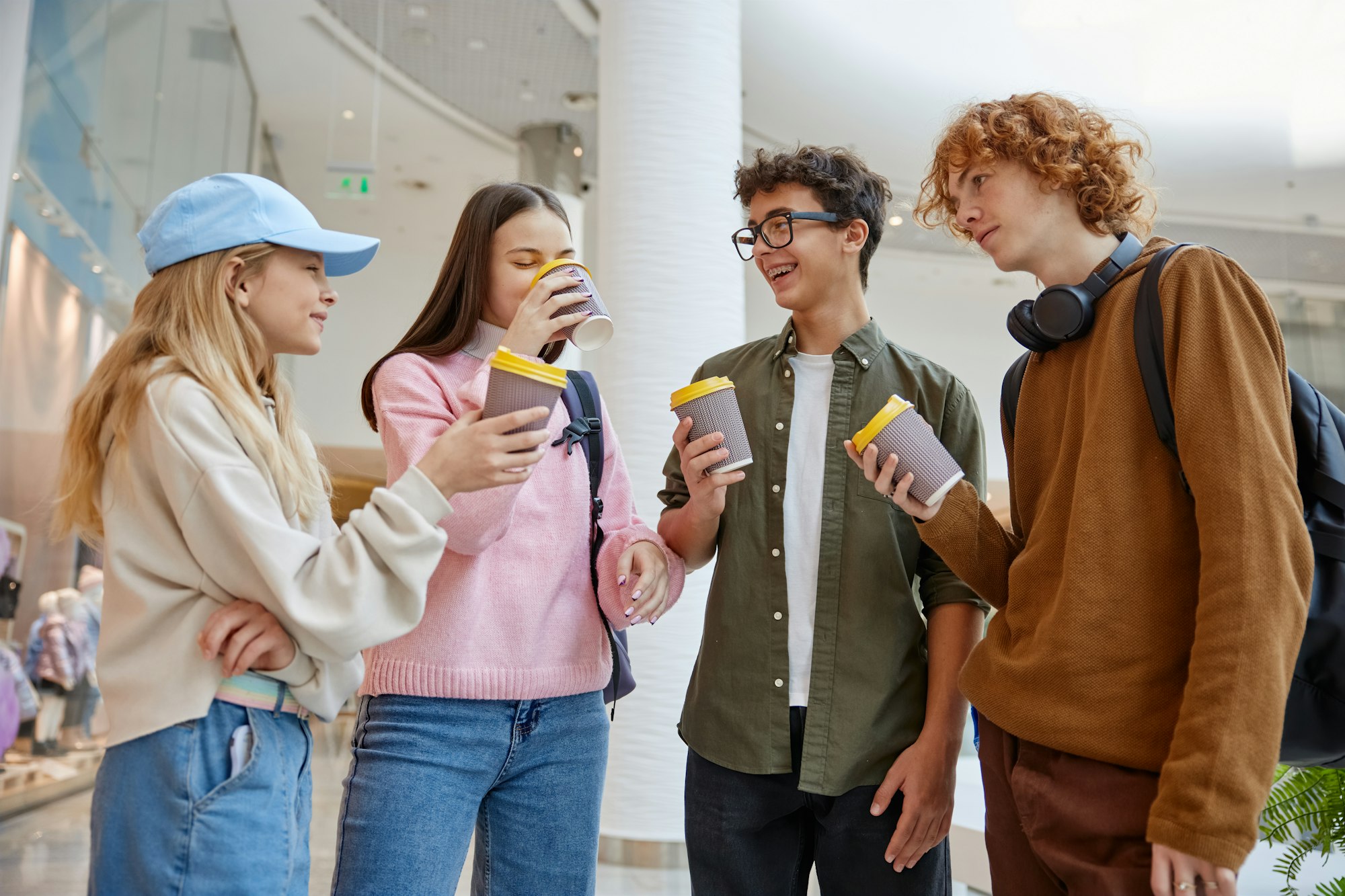 Group of children drinking coffee sharing emotion during shopping time